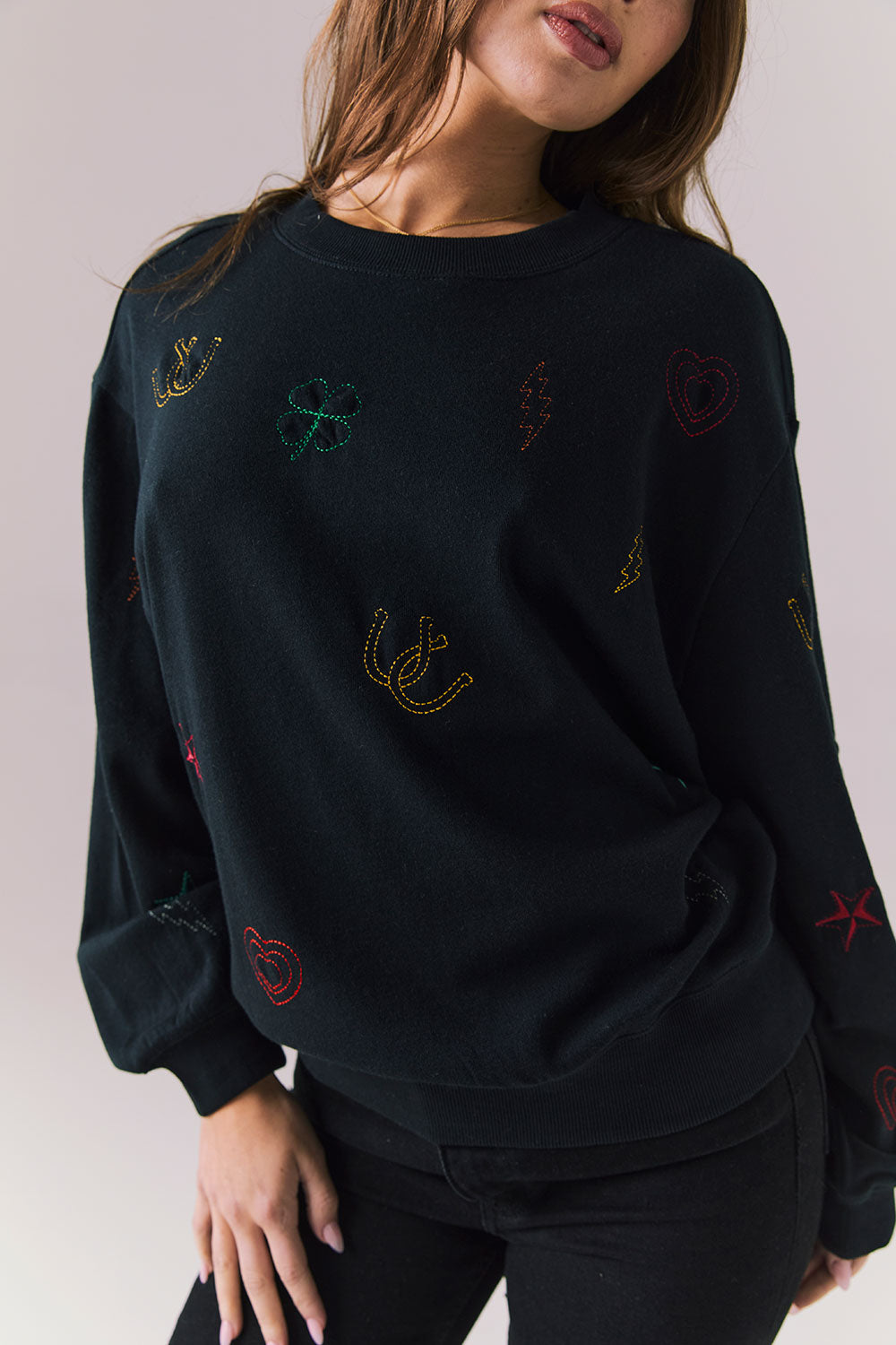 Front view of model wearing Allover Icons Long Sleeve in black