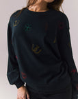 Front view of model wearing Allover Icons Long Sleeve in black