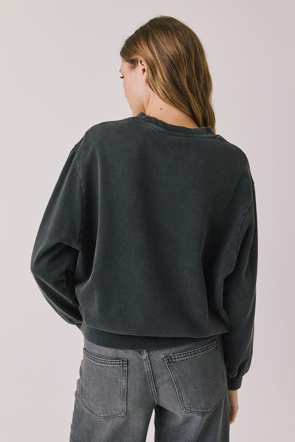 Back view of woman wearing Chaser’s Red Hearts Black Mineral Wash Long Sleeve on a light pink background