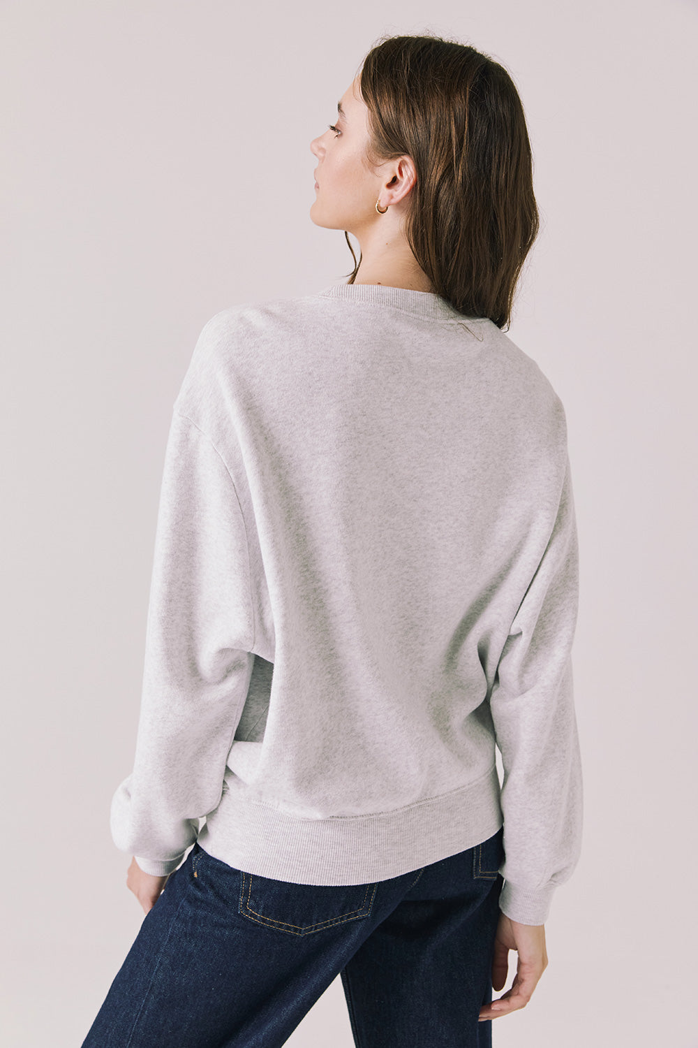 Back view of woman wearing Chaser’s light grey USA Sports Club Long Sleeve on a white background