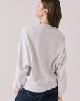 Back view of woman wearing Chaser’s light grey USA Sports Club Long Sleeve on a white background