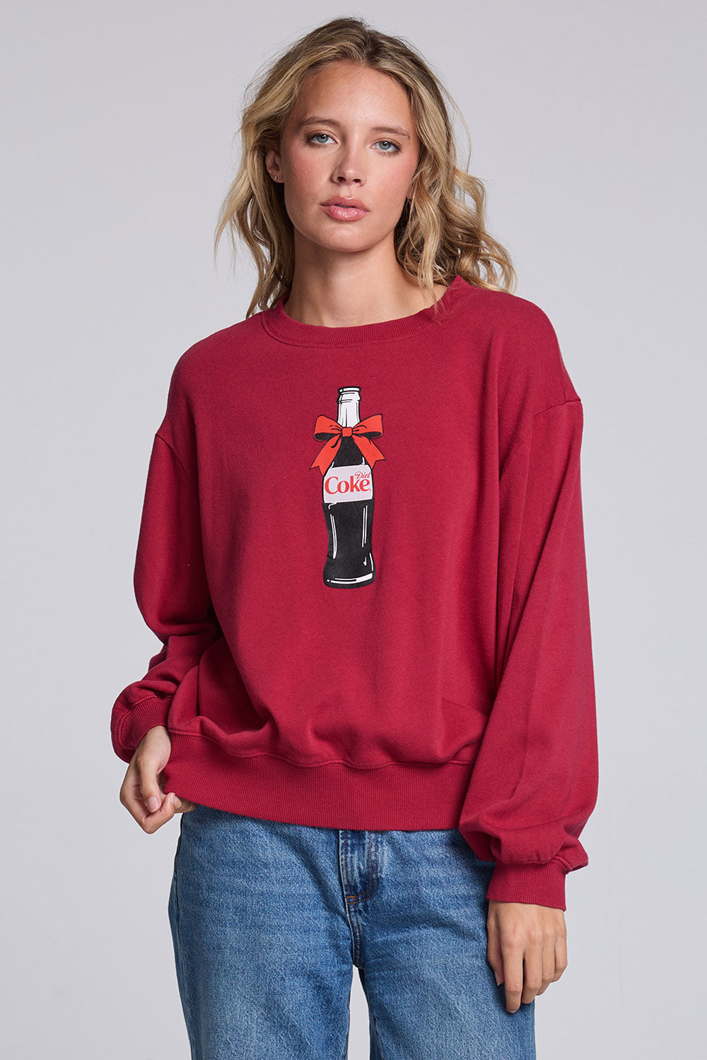 Model wearing Chaser's Coca-Cola Holiday Coke Pullover in Winter Garnet red with vintage Coca-Cola bottle artwork, front view