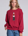 Model wearing Chaser's Coca-Cola Holiday Coke Pullover in Winter Garnet red with vintage Coca-Cola bottle artwork, front view