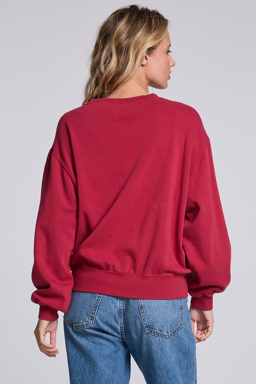 Model wearing Chaser's Coca-Cola Holiday Coke Pullover in Winter Garnet red with vintage Coca-Cola bottle artwork, back view