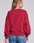 Model wearing Chaser's Coca-Cola Holiday Coke Pullover in Winter Garnet red with vintage Coca-Cola bottle artwork, back view