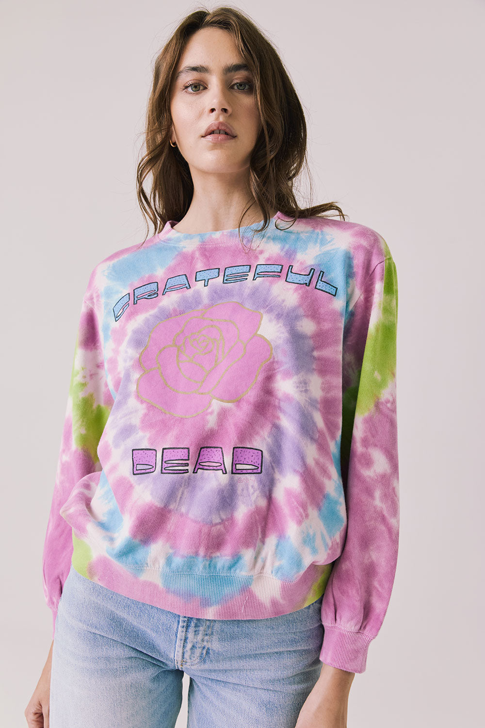 Front view of woman wearing Chaser’s Grateful Dead Rose Logo Long Sleeve with tie-dye pattern on a plain background