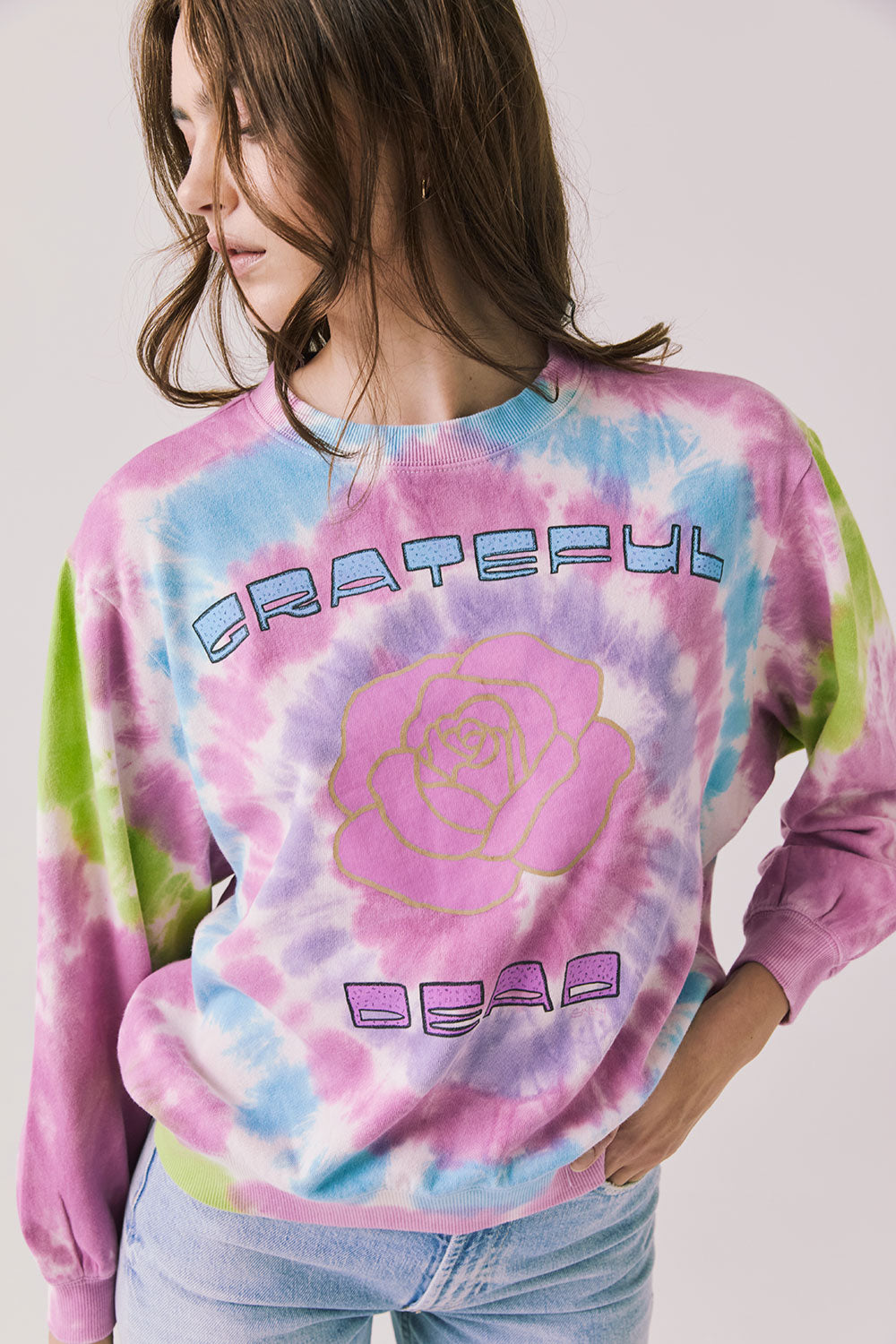 Front view of woman wearing Chaser’s Grateful Dead Rose Logo Long Sleeve with tie-dye pattern on a plain background