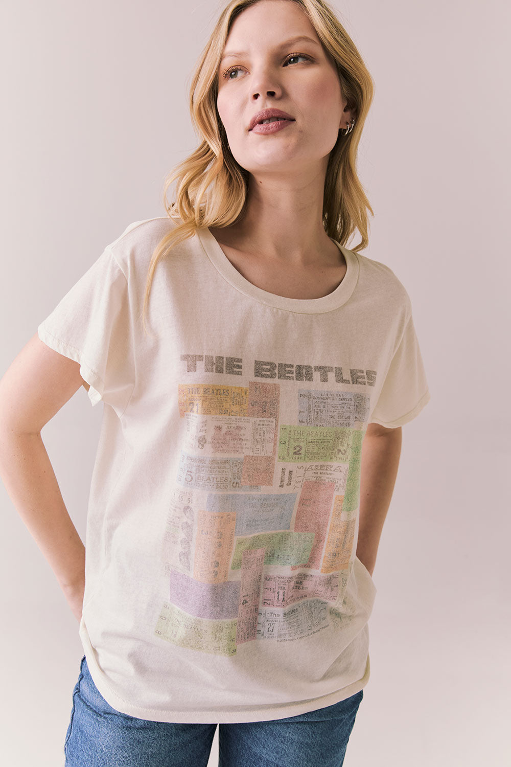 Front view of The Beatles Ticket Stub Collage Tee in Starry White with vintage ticket graphic and classic band logo against a plain background