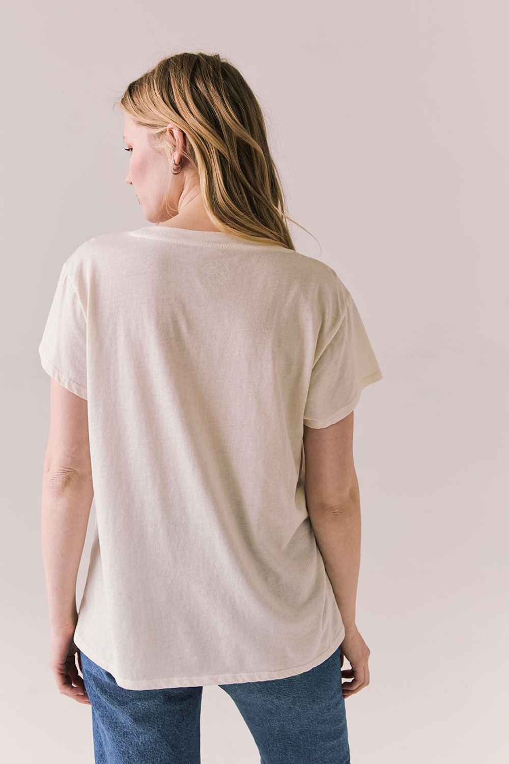 Back view of The Beatles Ticket Stub Collage Tee in Starry White with vintage ticket graphic and classic band logo against a plain background