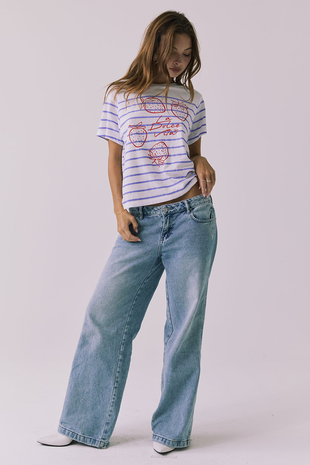 Full body view of the Chaser La Dolce Vita Tee styled with denim for an easy everyday look