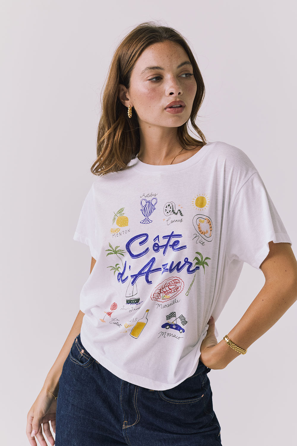 Angled front view of the Chaser Costa Del Sol Tee in White showing the vintage inspired Costa Del Sol graphic and lightweight drape