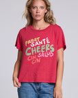 Model wearing Chaser's Cheers Tee in Cherry Bomb red with French-style celebratory lettering, front view