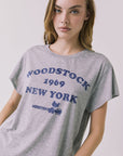 Close up view of the Chaser Woodstock 1969 New York Tee highlighting the licensed band collaboration print and heathered fabric texture