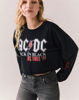 Side view of AC/DC UK Tour ’80 Tee in True Black with vintage UK Tour 1980 poster graphic and cropped long-sleeve fit on plain background