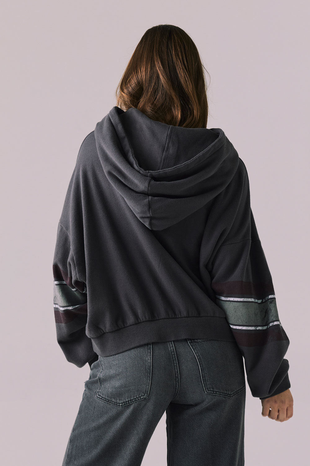 Back view of model wearing the Halftime fleece pullover hoodie in True Black with ‘HALFTIME’ chest graphic, against a plain background.