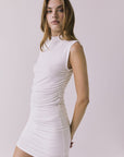 Side view of the Chaser Hailey White Top highlighting the ruched side seam and mock neckline with a close comfortable fit