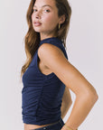Side view of the Chaser Hailey Navy Top showing the ruched side seam and flattering fitted shape