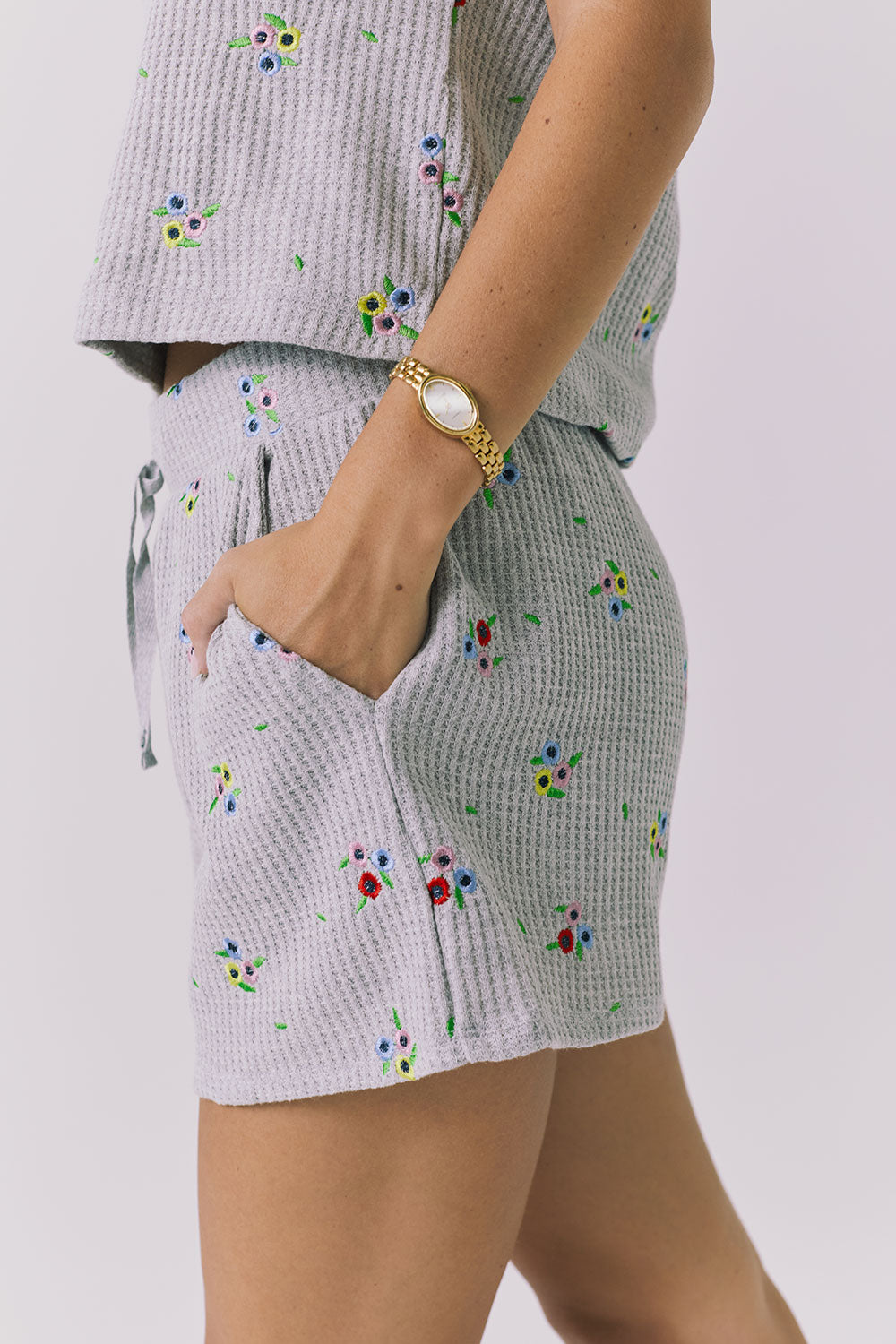 Chaser Kesh Short in Heather Grey with ditsy embroidery shown from the side highlighting the soft waffle fabric embroidered floral detail and side pocket construction