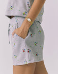 Chaser Kesh Short in Heather Grey with ditsy embroidery shown from the side highlighting the soft waffle fabric embroidered floral detail and side pocket construction