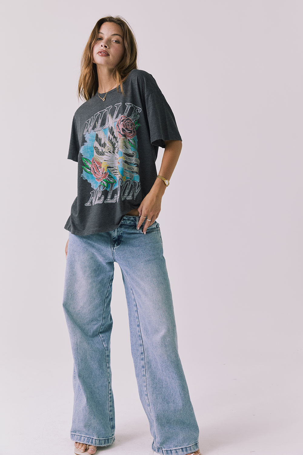 Full body view of the Chaser Willie Nelson On The Road Again Tee in Vintage Black styled casually with denim for an everyday look