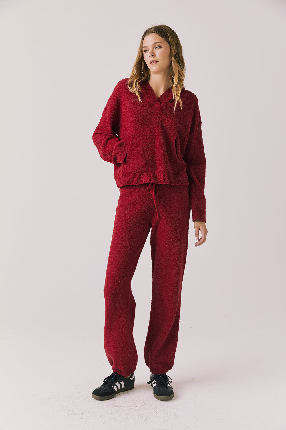 Full body view of woman wearing Chaser’s Hazen Purple-Red Fig Pullover Hoodie with matching Monica Purple-Red Fig Joggers on a white background