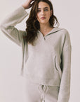 Front view of woman wearing Chaser’s Hazen Heather Grey Pullover hoodie on a white background