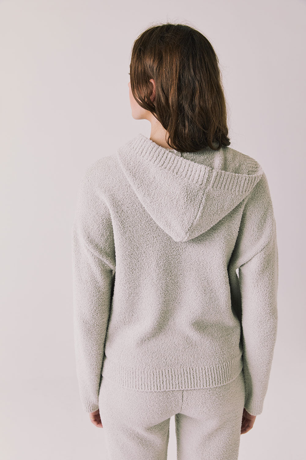 Back view of woman wearing Chaser’s Hazen Heather Grey Pullover on a white background