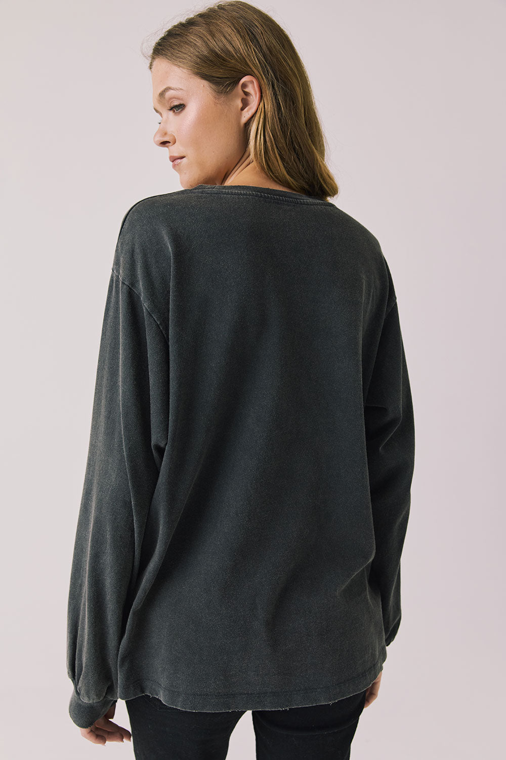 Back view of woman wearing Chaser’s Grateful Dead Disco Stealie Long Sleeve on a plain background