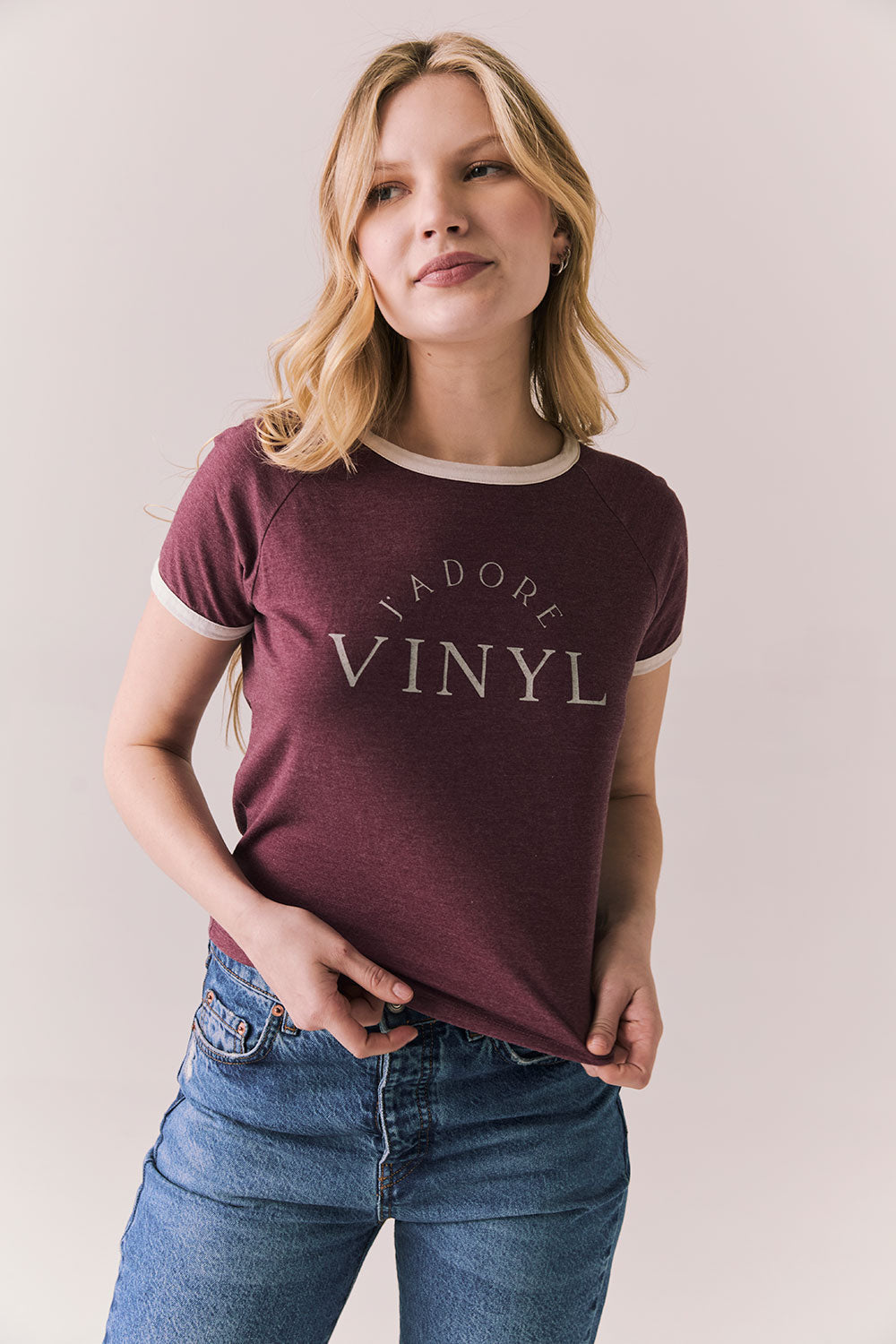 Front view of model in J’adore Vinyl Tee in fig purple with cream ringer trim and vintage-style text