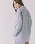 Chaser Paso Pinstripe Button Up in Navy shown over shoulder with fluid lightweight texture