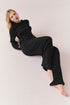 Model wearing black Sandyy trousers styled with matching pullover for full lounge set look.