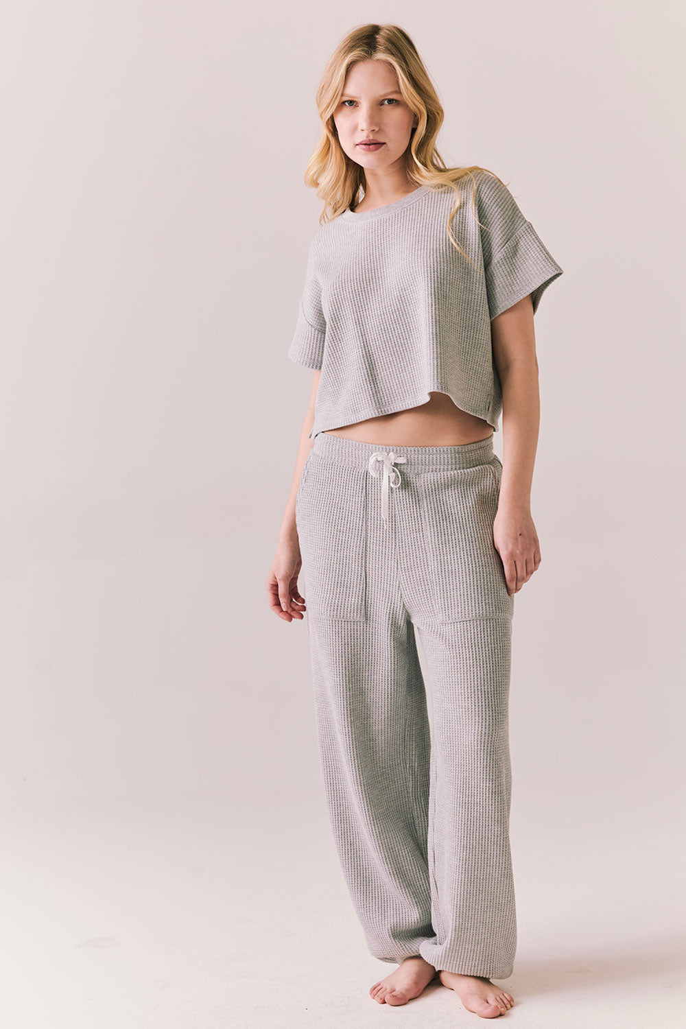 Full front view of model in Irvine Tee in heather grey with soft thermal texture with matching Billy Joggers against a plain background