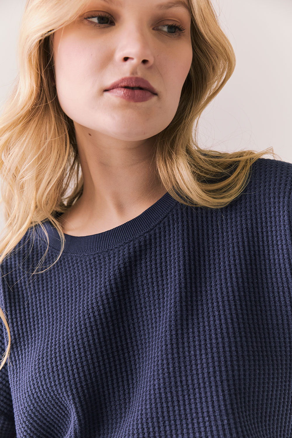 Front view of model in Irvine Tee in midnight blue with soft thermal texture on plain background
