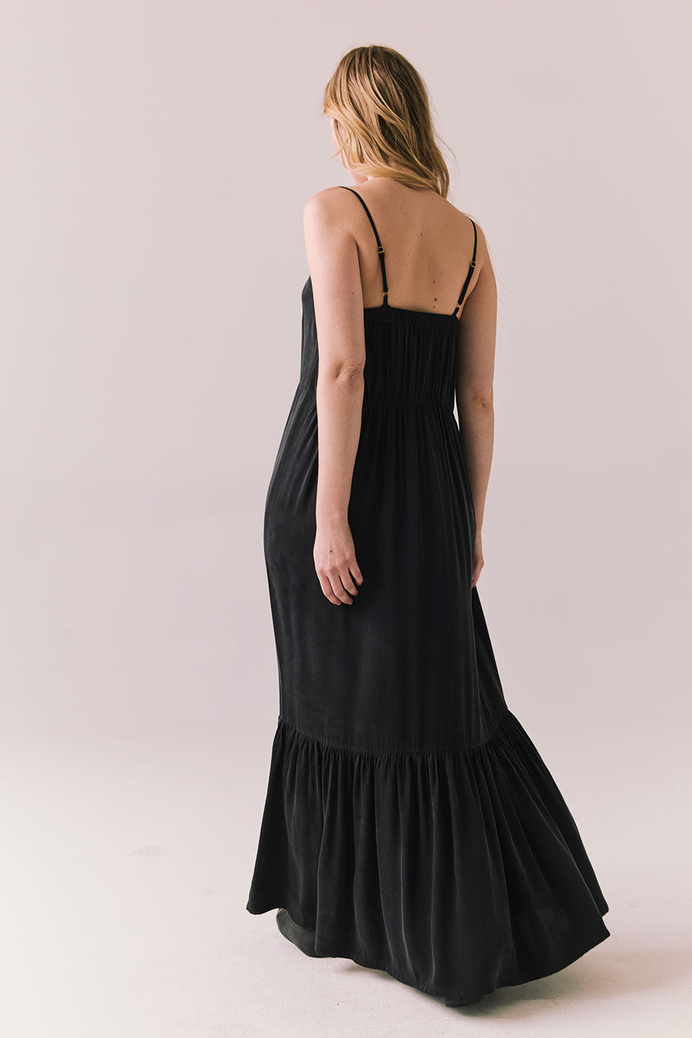 Back full body view of model in Berkeley Maxi Dress in true black