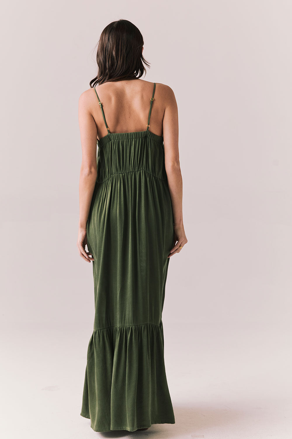 Back of woman wearing the Berkeley Maxi Flowy Silky Dress in Green against a white background