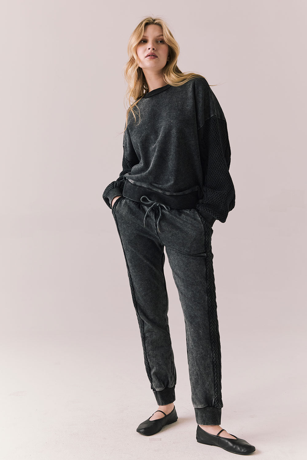 Full front view of Maritime Pullover in True Black with relaxed fit and knit texture and matching Bay Joggers against a plain background