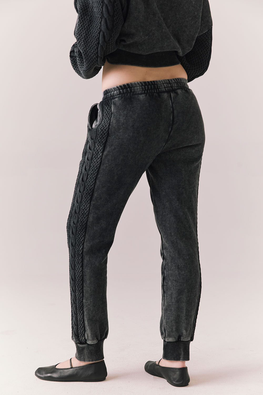 Back view of model wearing Bay Joggers in true black