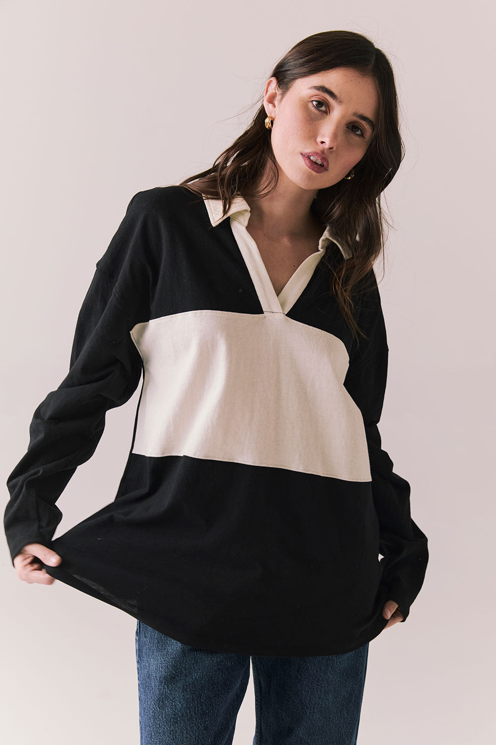 Front view of woman wearing a black and white Chico long sleeve with striped design against a plain background