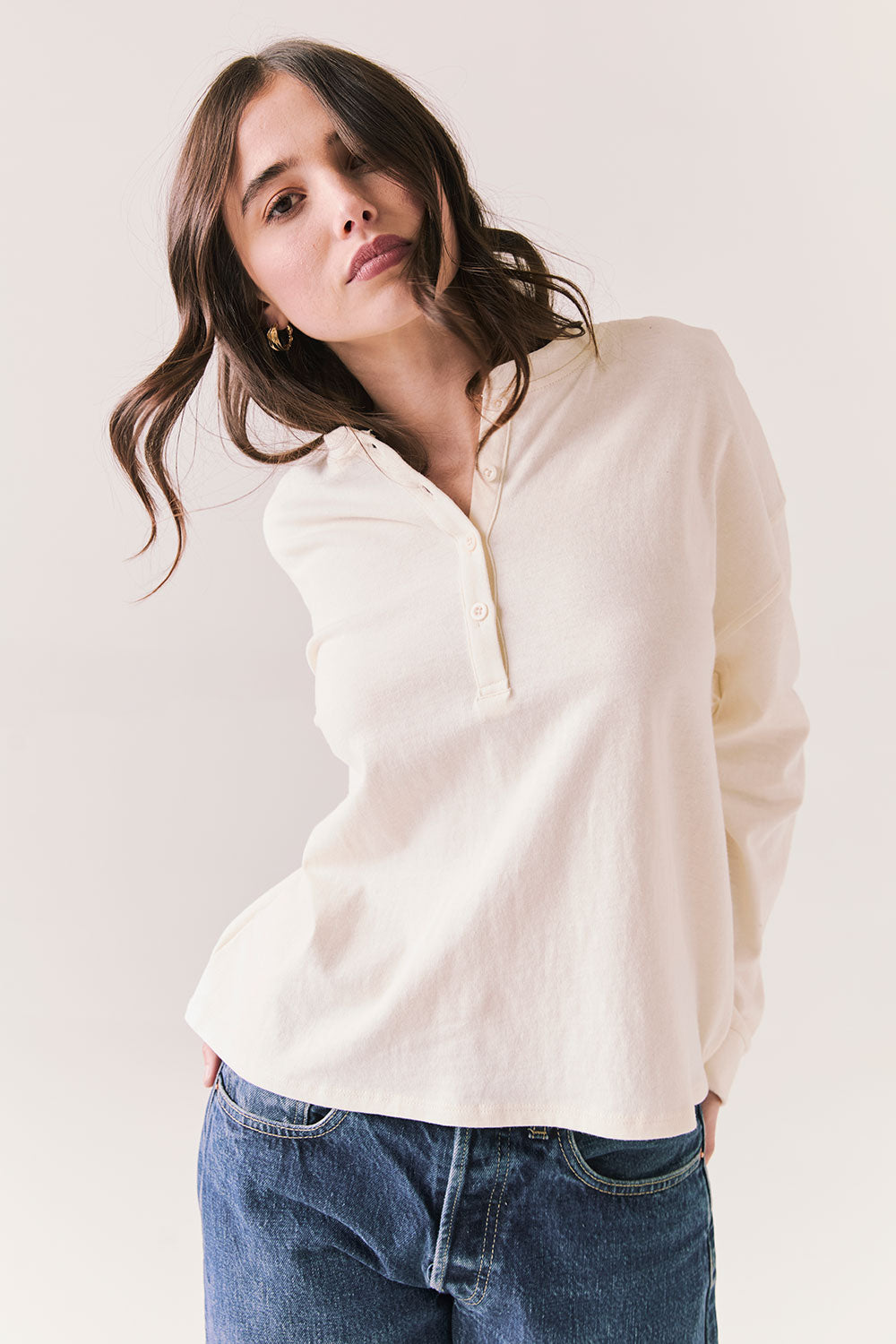 Front view of model wearing the Humboldt long sleeve in starry white with soft cotton texture and blue jeans against a white background