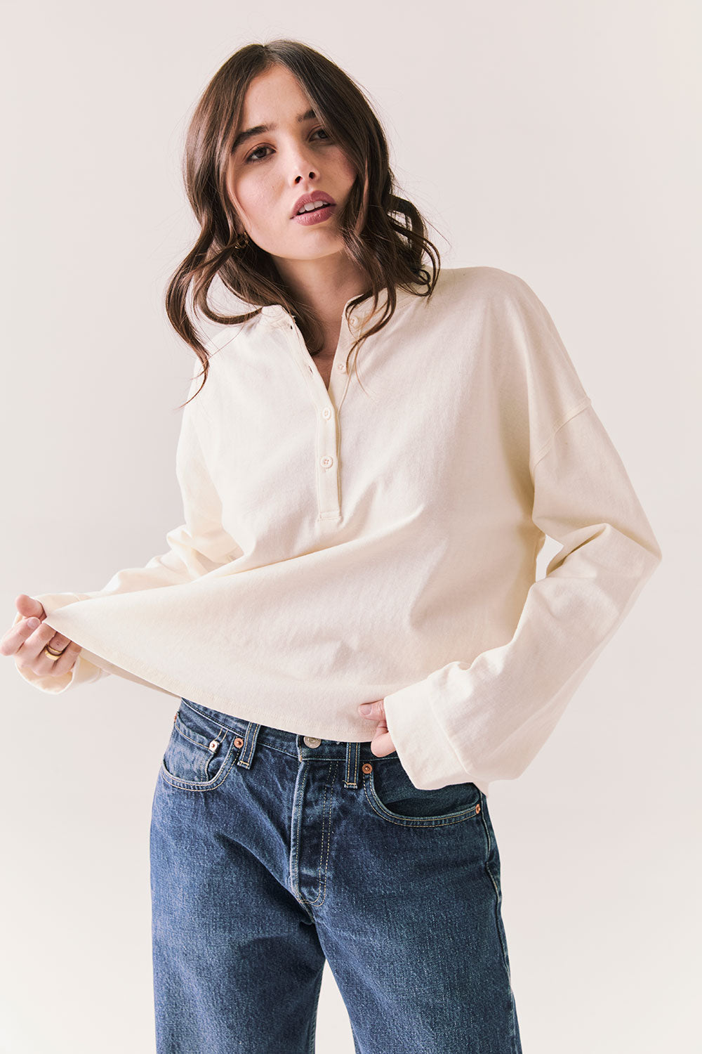 Front view of model wearing the Humboldt long sleeve in starry white with soft cotton texture and blue jeans against a white background