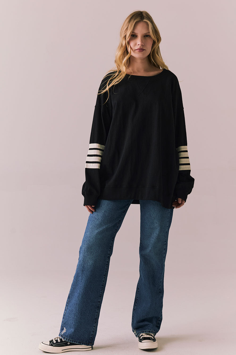 Full front view of Pomona Long Sleeve in black and white with bold stripes and gigot sleeves with blue denim against a plain background