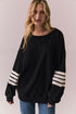 Front view of Pomona Long Sleeve in black and white with bold stripes and gigot sleeves against a plain background