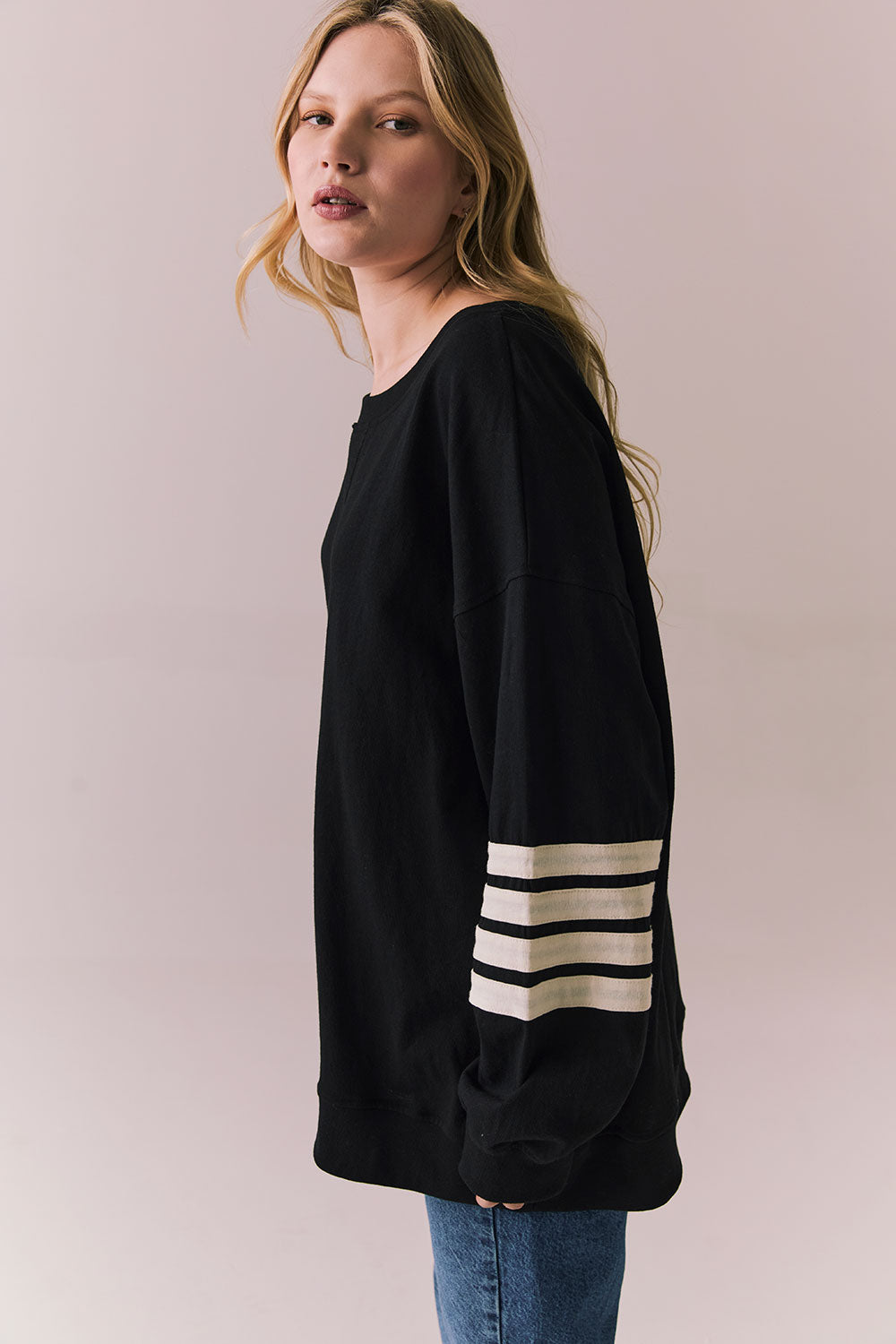 Side view of Pomona Long Sleeve in black and white with bold stripes and gigot sleeves against a plain background