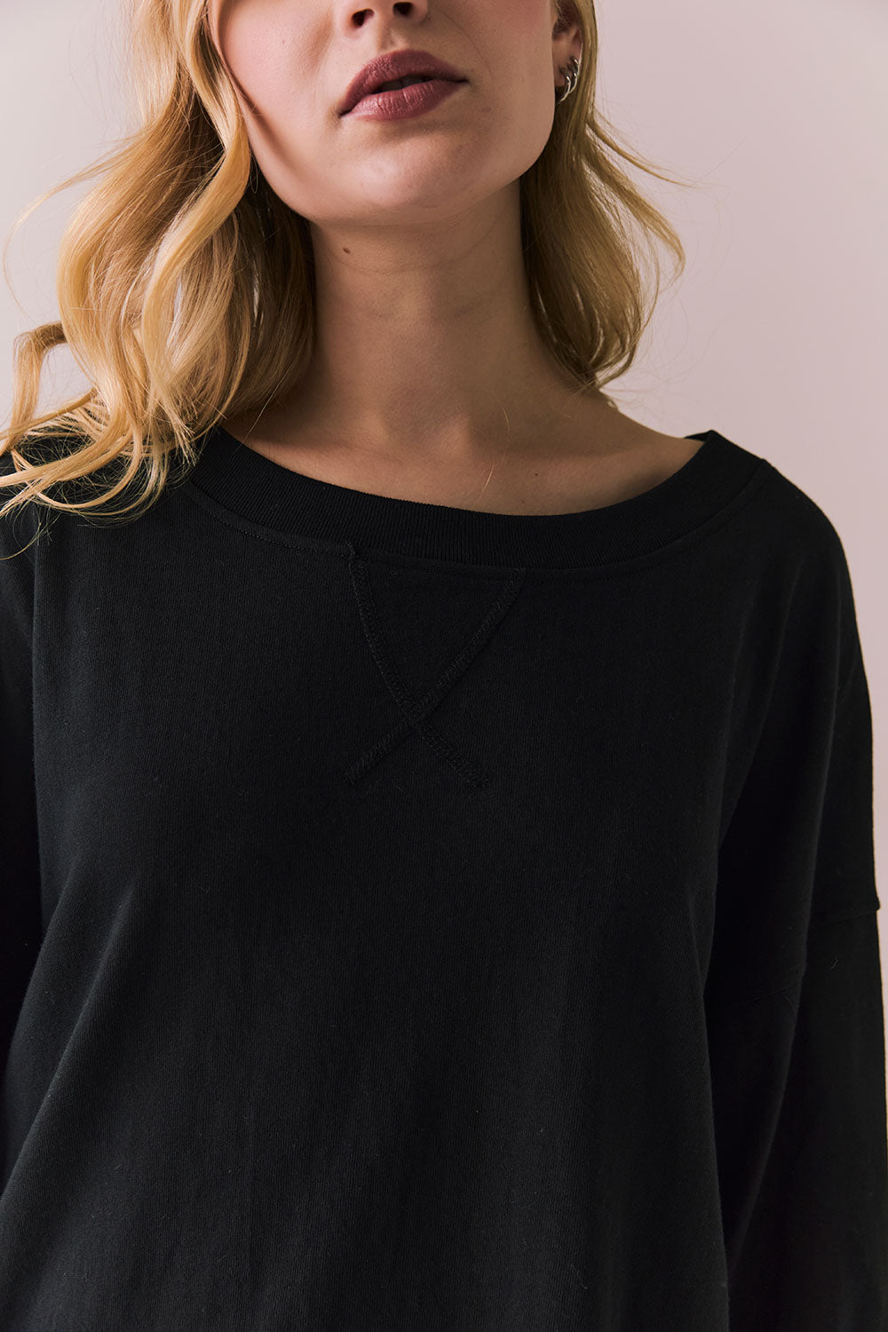 Closeup view of Pomona Long Sleeve in black and white with bold stripes and gigot sleeves against a plain background