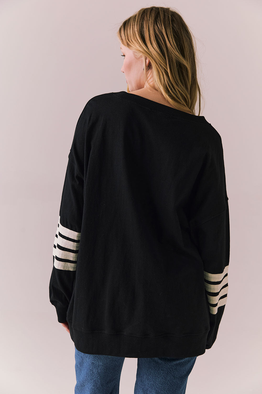 Back view of Pomona Long Sleeve in black and white with bold stripes and gigot sleeves against a plain background