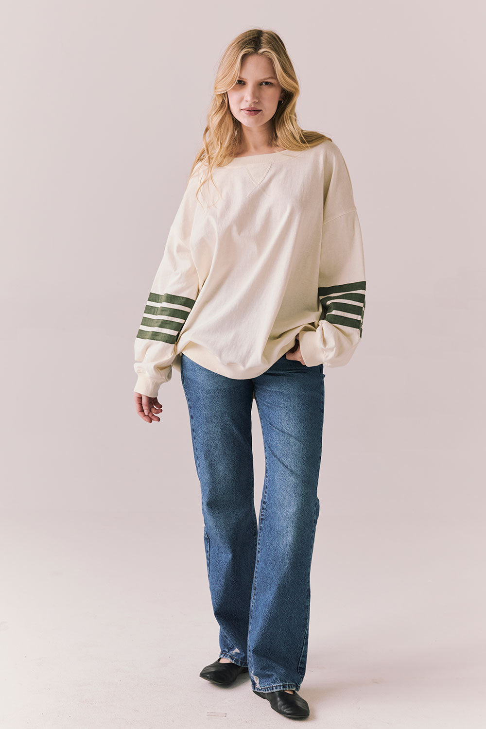 Full front view of Pomona long sleeve in Starry White with Bronze Green stripes and gigot sleeves with blue denim against a plain background