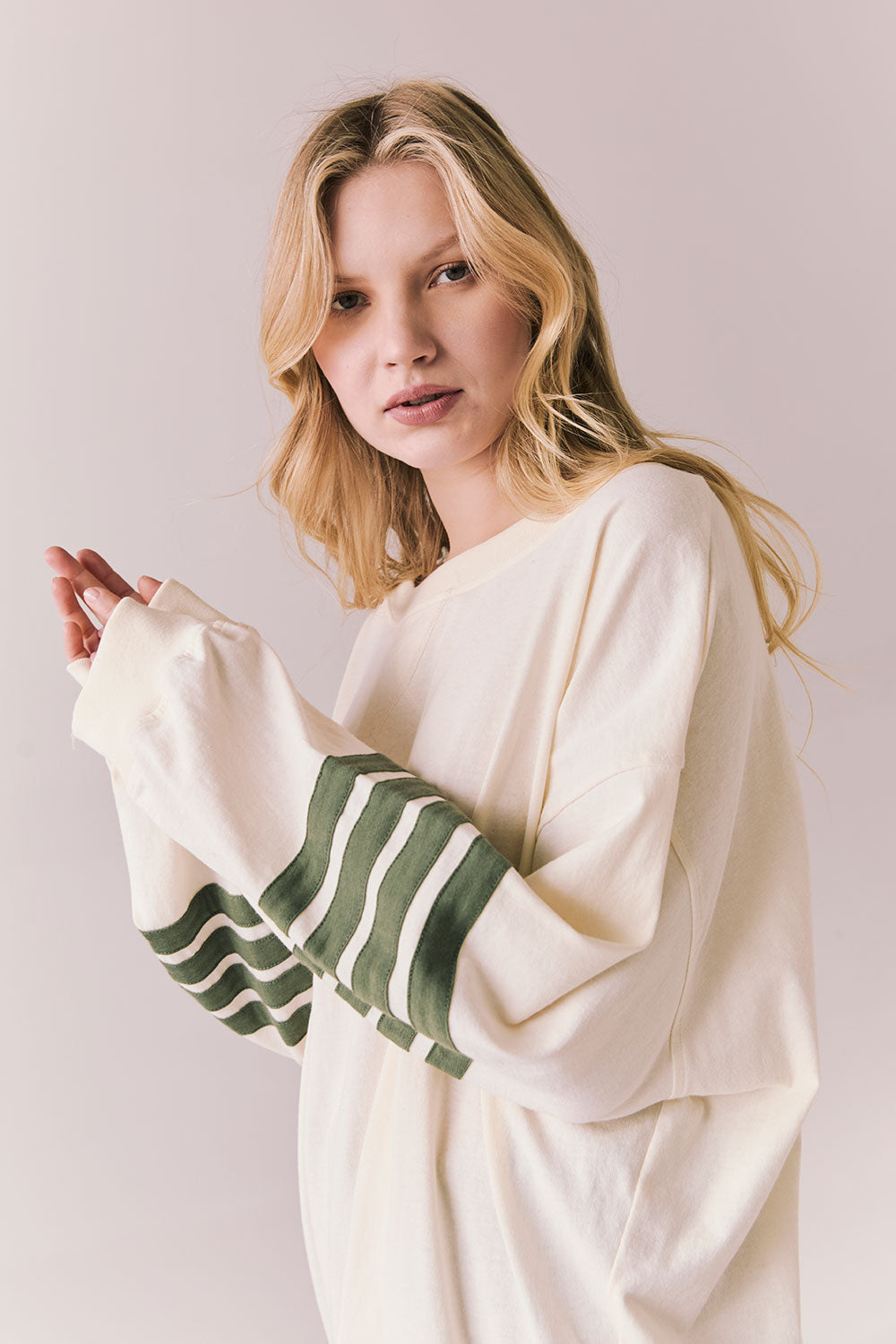 Side view of Pomona long sleeve in Starry White with Bronze Green stripes and gigot sleeves against a plain background