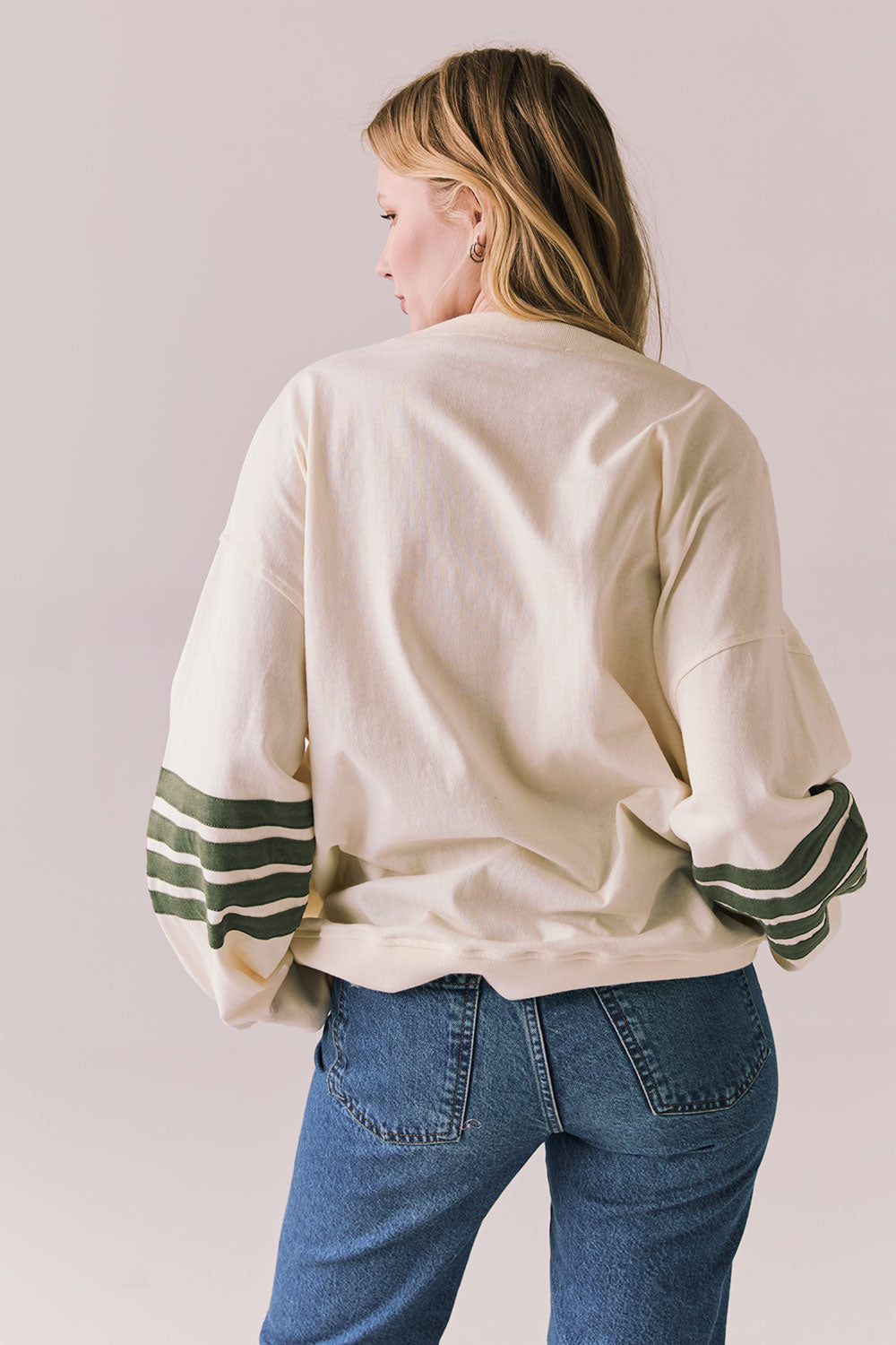 Back view of Pomona long sleeve in Starry White with Bronze Green stripes and gigot sleeves against a plain background