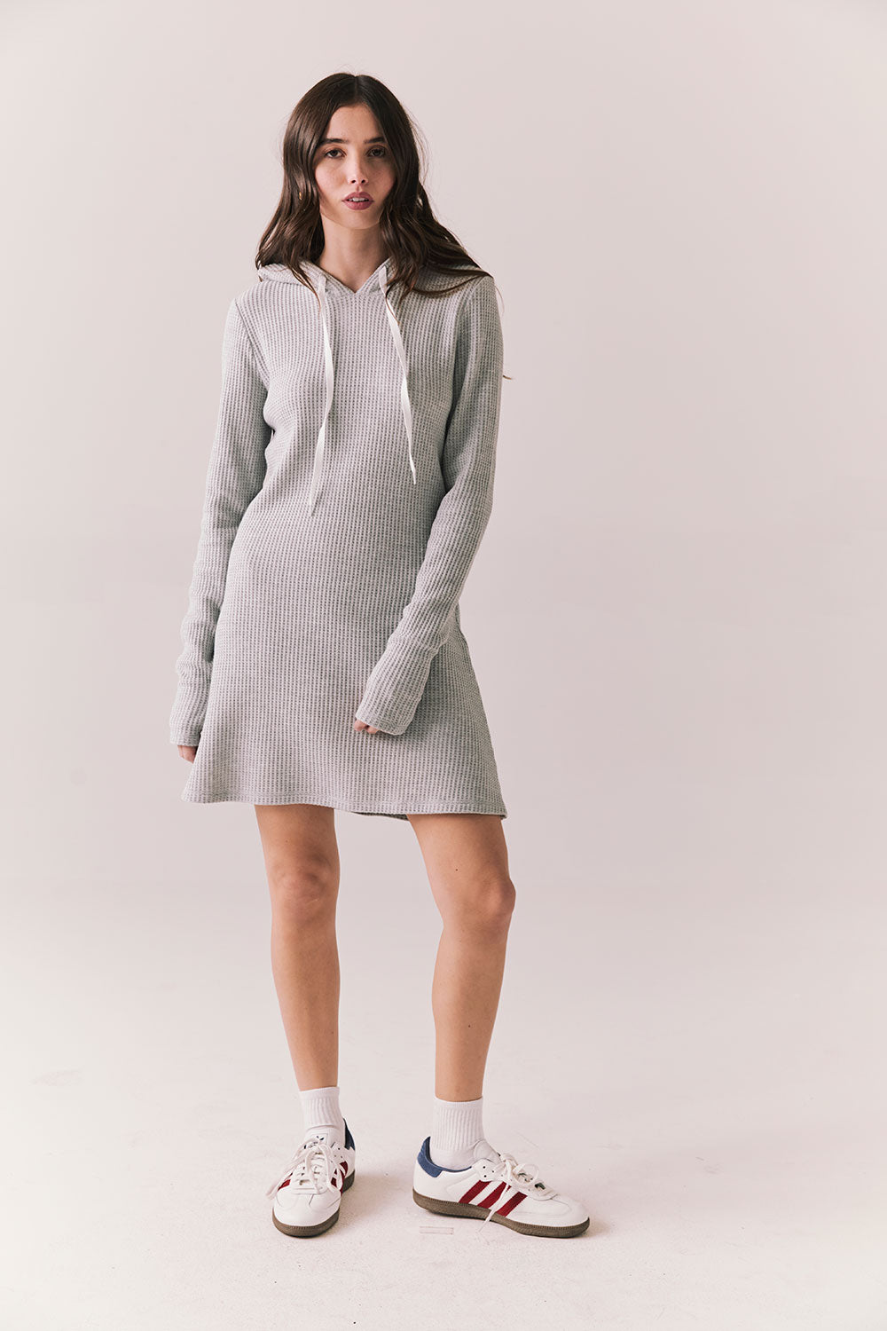 Full front view of model wearing Merced Hoodie Dress in Heather Grey with hood and thermal knit texture against a plain background