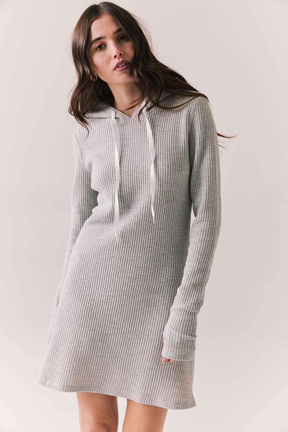 Front view of model wearing Merced Hoodie Dress in Heather Grey with hood and thermal knit texture against a plain background